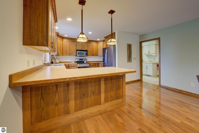 1339 Killdeer Ln, Kingsley, MI 49649 - kitchen with a sink, light countertops, appliances with stainless steel finishes, and light wood-style floors