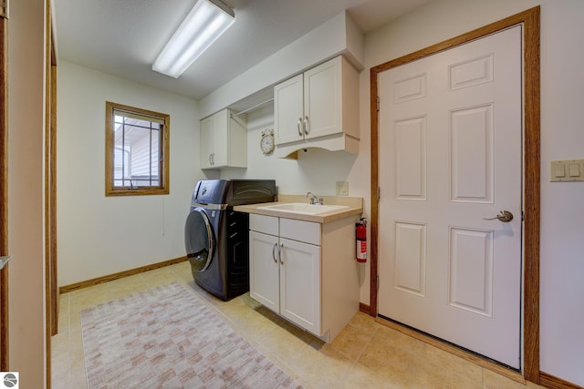1339 Killdeer Ln, Kingsley, MI 49649 - clothes washing area with cabinet space, baseboards, washer / dryer, and a sink