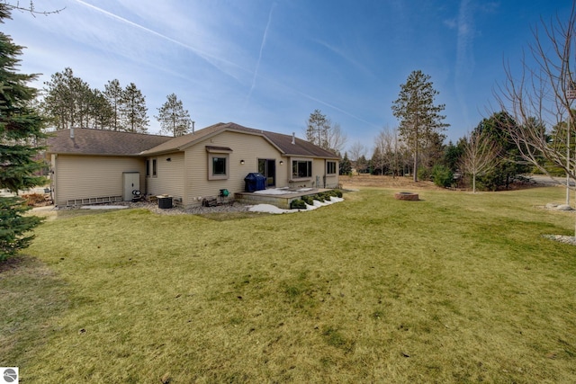 1339 Killdeer Ln, Kingsley, MI 49649 - rear view of property with a yard and an outdoor fire pit