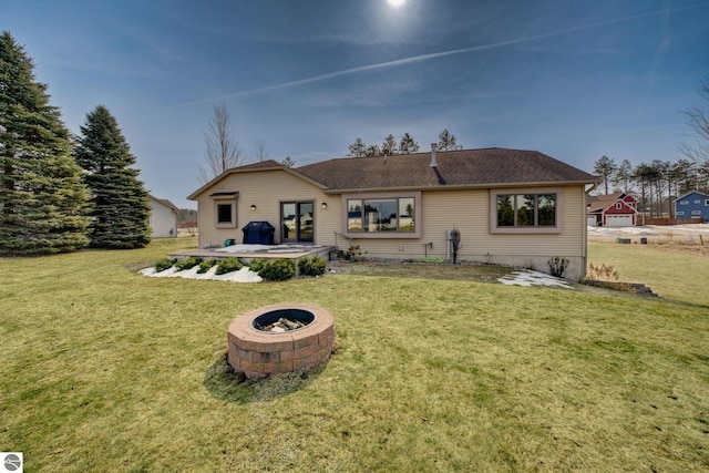 1339 Killdeer Ln, Kingsley, MI 49649 - rear view of house featuring a patio area, an outdoor fire pit, and a lawn