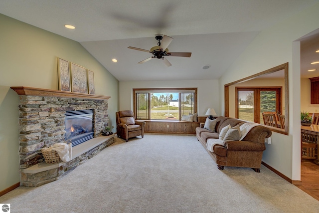 1339 Killdeer Ln, Kingsley, MI 49649 - carpeted living room with baseboards, ceiling fan, a fireplace, and vaulted ceiling