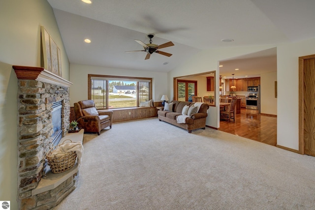 1339 Killdeer Ln, Kingsley, MI 49649 - living room featuring a stone fireplace, ceiling fan, recessed lighting, light colored carpet, and lofted ceiling