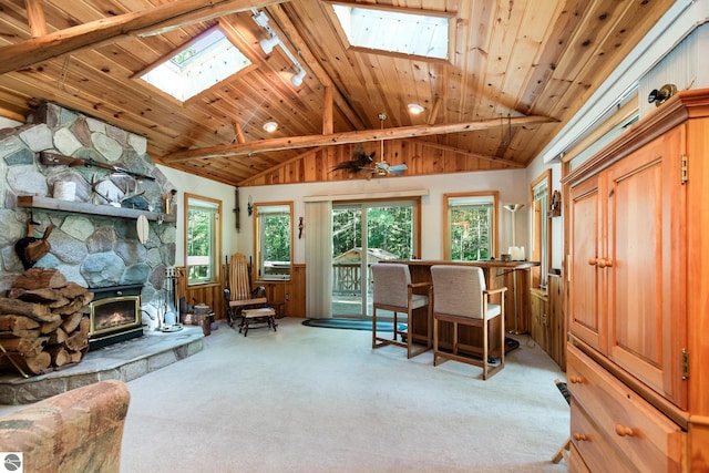 home office with track lighting, a fireplace, lofted ceiling with skylight, carpet, and wooden ceiling