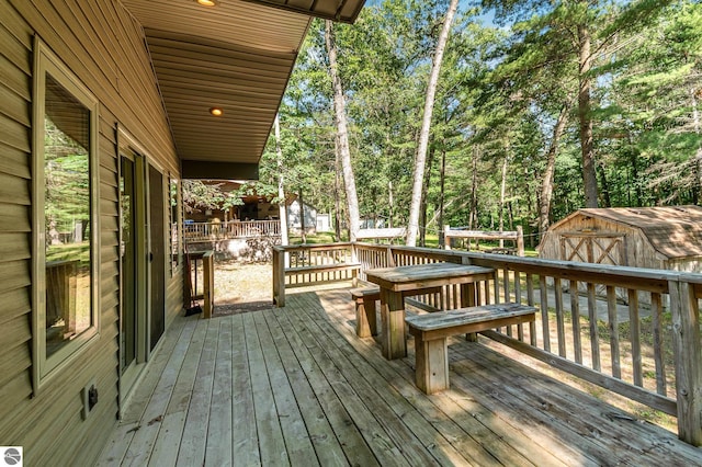 deck featuring a storage shed and an outdoor structure