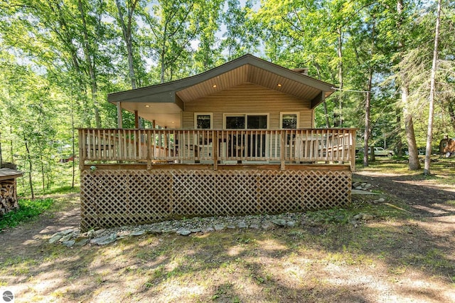 rear view of property featuring a wooden deck