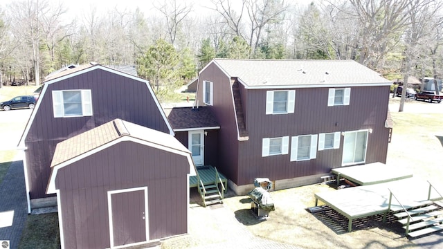 7119 Lakewood Dr, Oscoda, MI 48750 - rear view of property with roof with shingles and entry steps