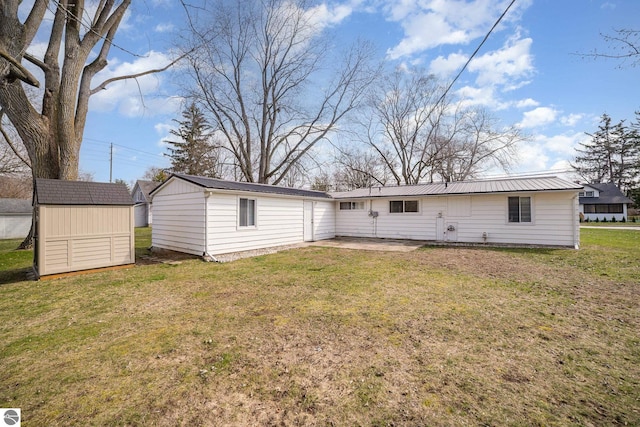 316 Grafton Ave, Alma, MI 48801 - rear view of house with an outbuilding, a lawn, metal roof, and a shed