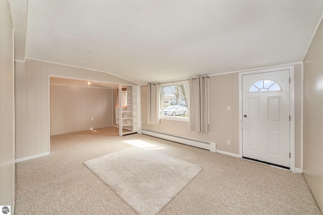 316 Grafton Ave, Alma, MI 48801 - carpeted entrance foyer with a baseboard heating unit and vaulted ceiling