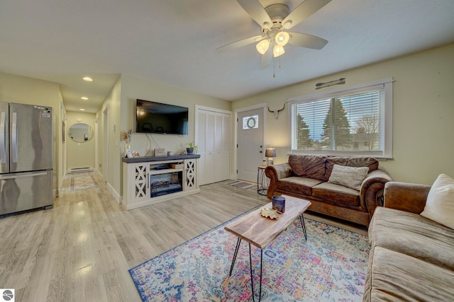 living room with recessed lighting, wood finished floors, baseboards, a baseboard radiator, and ceiling fan