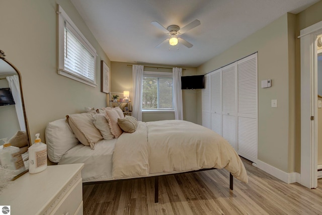 bedroom with baseboards, a ceiling fan, and wood finished floors