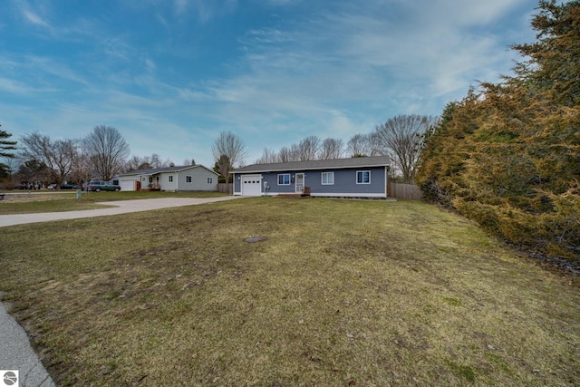 single story home featuring driveway, fence, a front yard, and a garage