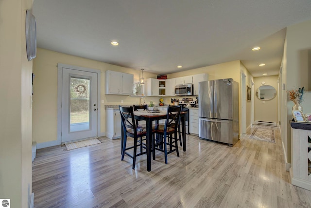 dining area with light wood-style flooring, baseboards, recessed lighting, and baseboard heating