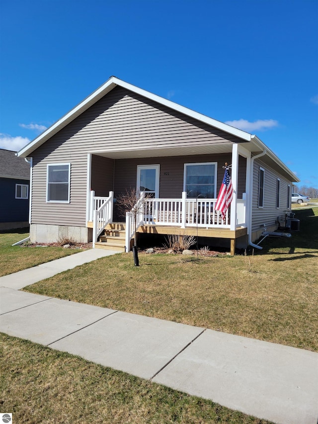 921 Cobalt St Unit 48, Traverse City, MI 49696 - view of front facade featuring covered porch and a front lawn