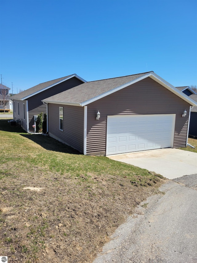 921 Cobalt St Unit 48, Traverse City, MI 49696 - view of side of home with a yard and concrete driveway
