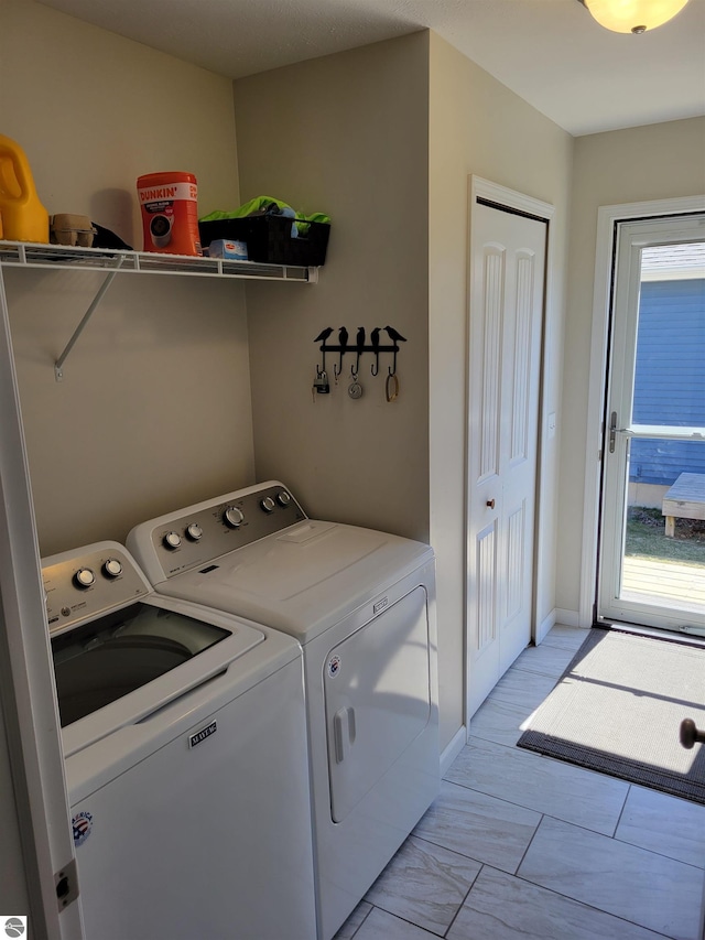 921 Cobalt St Unit 48, Traverse City, MI 49696 - laundry area featuring washer and dryer and baseboards