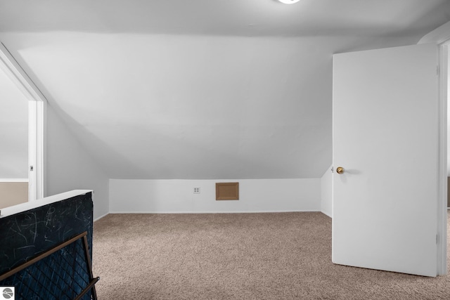 bonus room with baseboards, lofted ceiling, and carpet