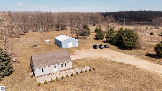 drone / aerial view featuring a rural view and a wooded view