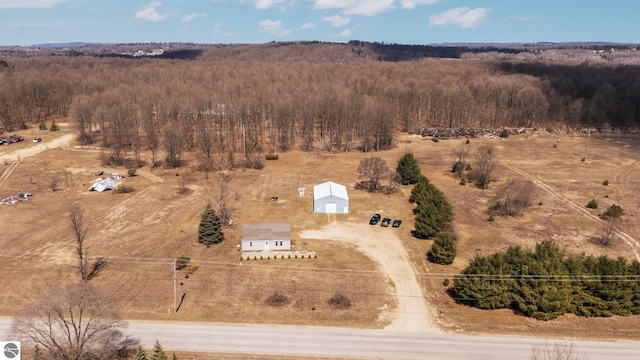 drone / aerial view featuring a rural view and a forest view