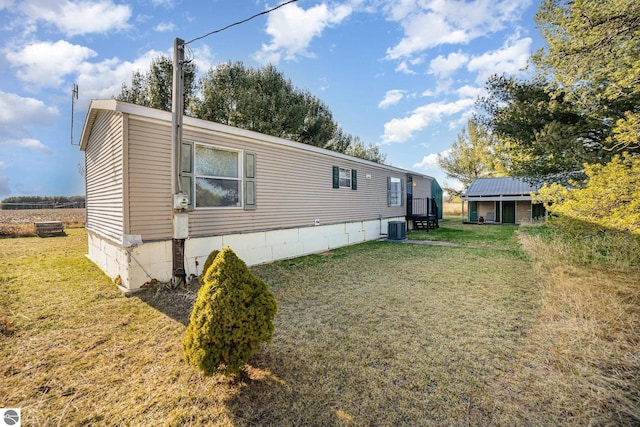 view of home's exterior with central AC and a lawn