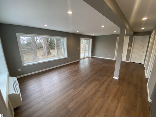 7228B S M-88, Bellaire, MI 49615 - unfurnished living room featuring dark wood finished floors, baseboards, and recessed lighting