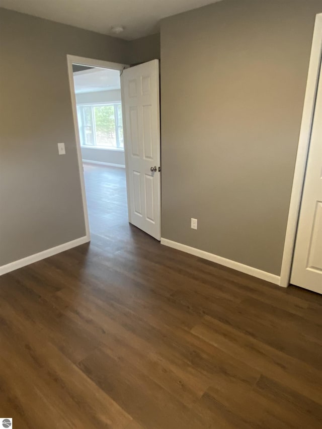 7228B S M-88, Bellaire, MI 49615 - empty room with dark wood-type flooring and baseboards