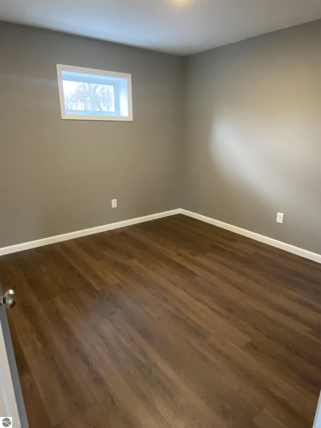 7228B S M-88, Bellaire, MI 49615 - spare room featuring dark wood finished floors and baseboards
