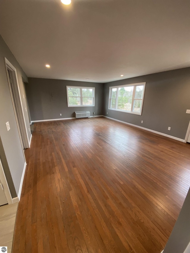 7228B S M-88, Bellaire, MI 49615 - spare room featuring hardwood / wood-style floors, baseboards, an AC wall unit, and recessed lighting