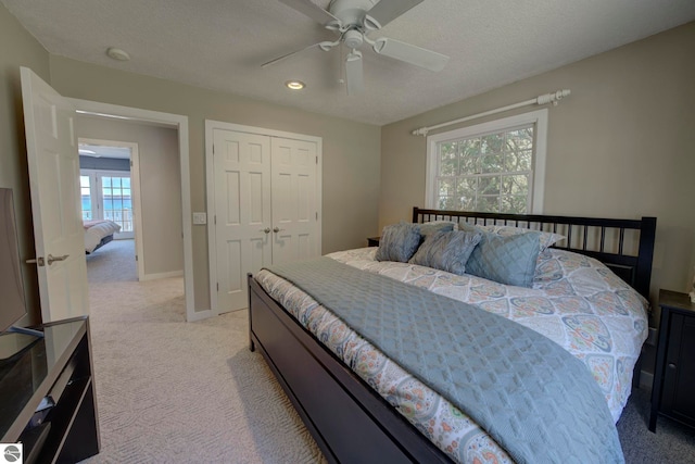 bedroom with recessed lighting, a closet, baseboards, light colored carpet, and ceiling fan