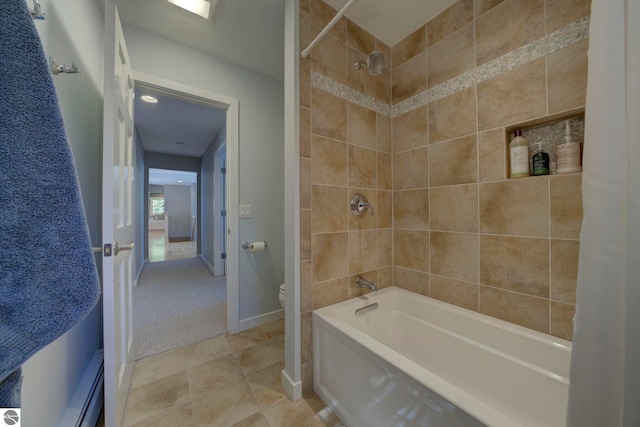 bathroom with shower / bath combination, baseboards, and toilet