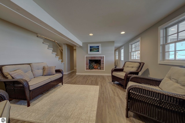 living area with recessed lighting, light wood-style flooring, a healthy amount of sunlight, and baseboards