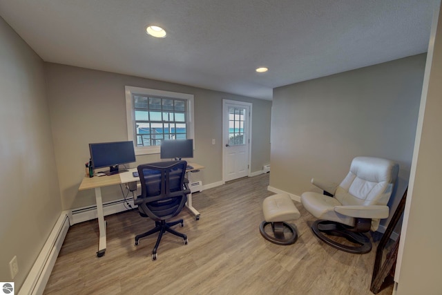 home office featuring a baseboard heating unit, wood finished floors, baseboards, and recessed lighting