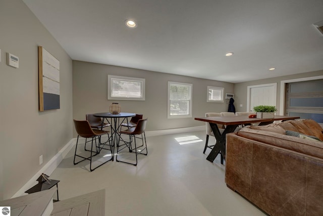 living area with baseboards, recessed lighting, and finished concrete flooring