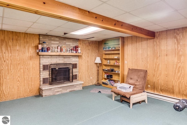 7726 Anway Dr, Battle Creek, MI 49014 - living area featuring a paneled ceiling, wood walls, and carpet floors