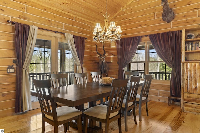dining area with lofted ceiling, wooden ceiling, an inviting chandelier, and light wood-style floors