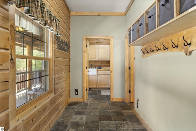 mudroom with baseboards and stone finish floor