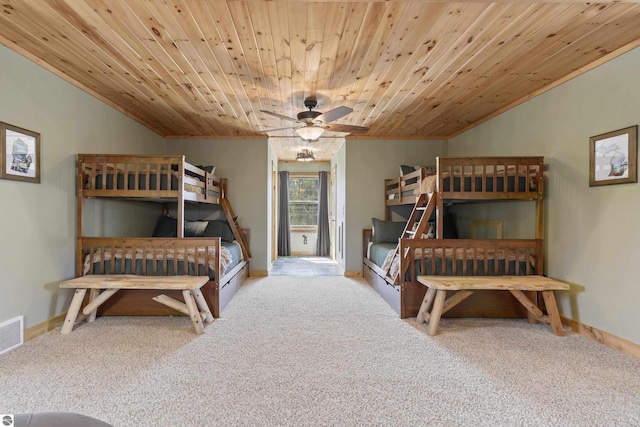 bedroom featuring carpet flooring, baseboards, lofted ceiling, wooden ceiling, and ornamental molding