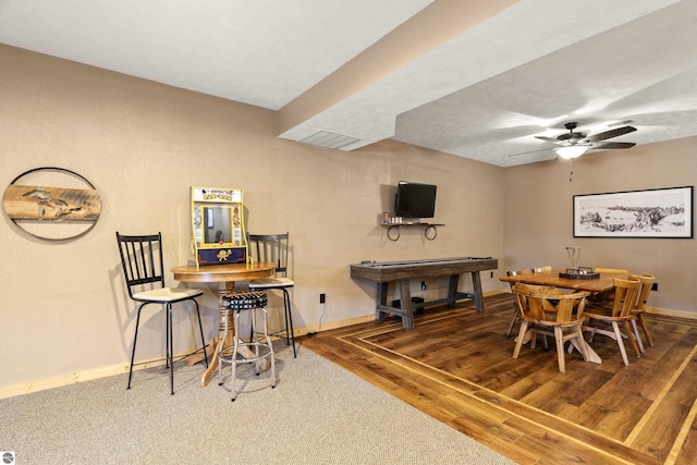 dining room featuring ceiling fan, baseboards, and wood finished floors