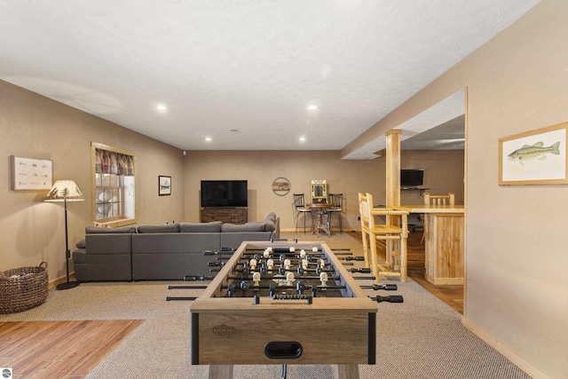 recreation room featuring recessed lighting, wood finished floors, and baseboards