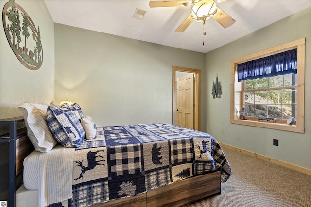 bedroom featuring ceiling fan, baseboards, visible vents, and carpet