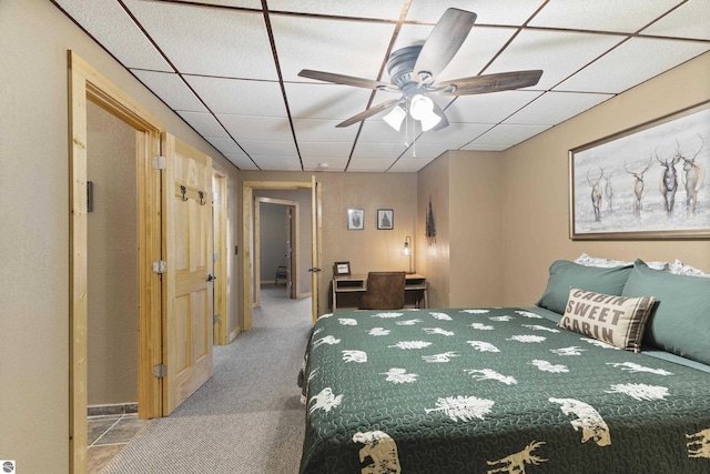 bedroom featuring carpet and a drop ceiling