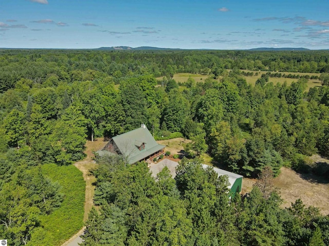 drone / aerial view featuring a wooded view
