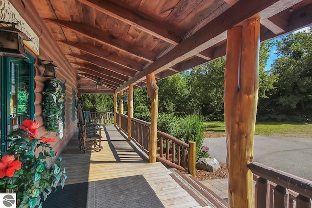 wooden terrace with a porch and a ceiling fan