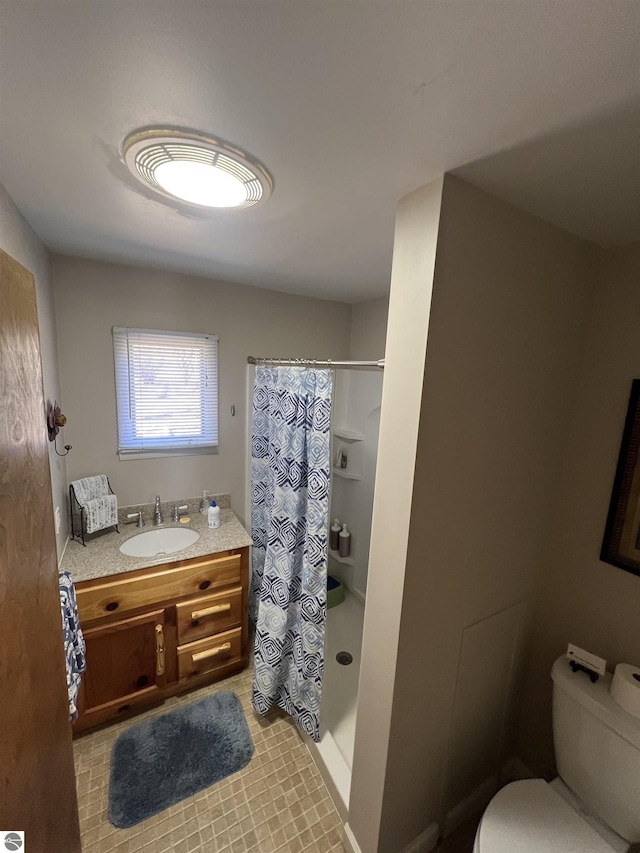 bathroom featuring toilet, a shower with curtain, and vanity