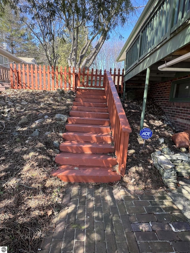 wooden deck featuring fence and stairs