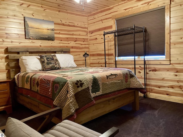 bedroom featuring wooden walls, carpet flooring, and wooden ceiling
