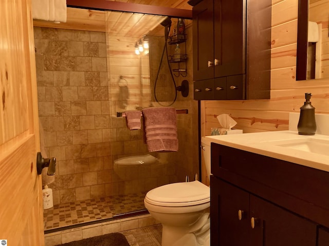bathroom with a shower stall, toilet, and vanity