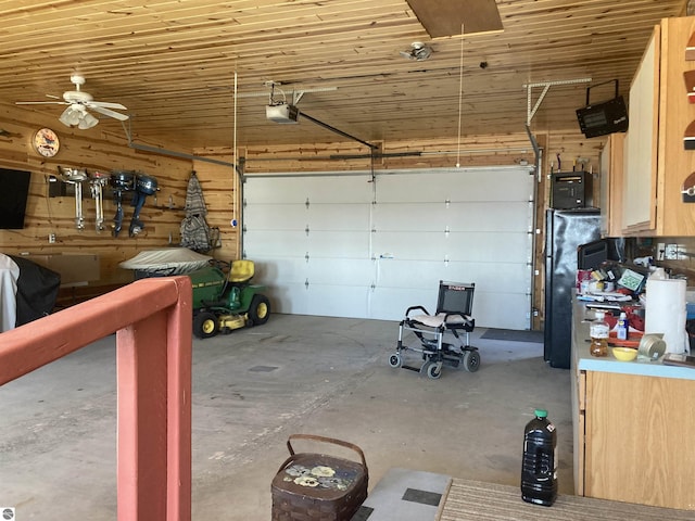 garage featuring wooden ceiling, a garage door opener, wood walls, and freestanding refrigerator