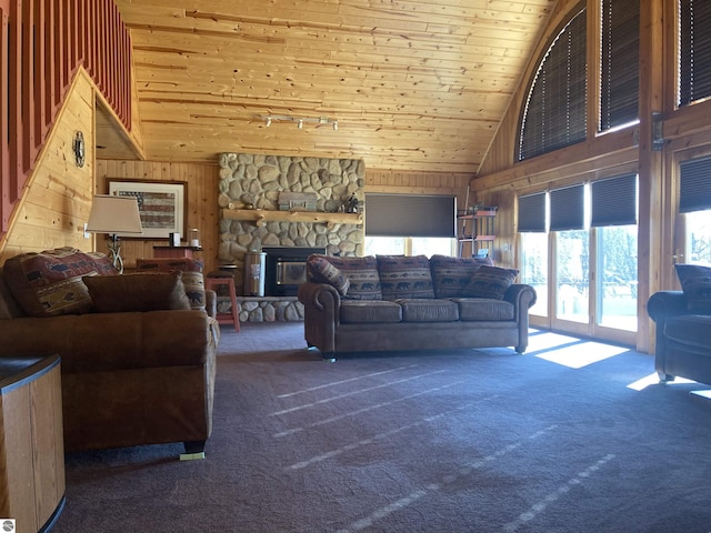 living room with wood ceiling, carpet floors, wood walls, and high vaulted ceiling