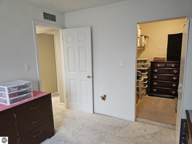 100 Fourth Ave Unit E-3, Tawas City, MI 48763 - carpeted bedroom featuring a spacious closet, visible vents, and a closet