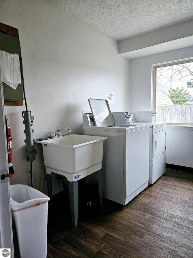 100 Fourth Ave Unit E-3, Tawas City, MI 48763 - clothes washing area with laundry area, a sink, dark wood-type flooring, washing machine and clothes dryer, and a textured ceiling